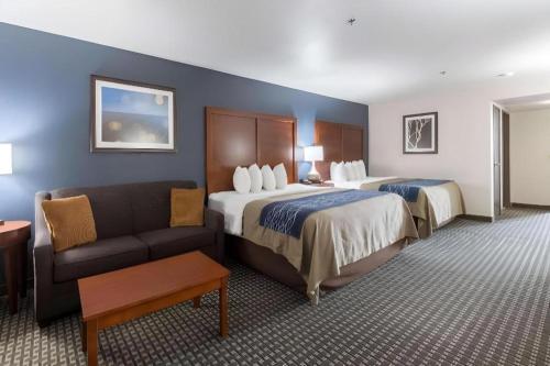a hotel room with two beds and a couch at Best Western Northwest Corpus Christi Inn & Suites in Calallen