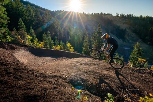 a man riding a bike on top of a hill at Grand Hyatt Deer Valley in Park City