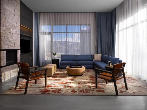 a living room with a blue couch and chairs at Grand Hyatt Deer Valley in Park City