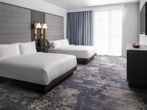 a hotel room with two beds and a television at Grand Hyatt Deer Valley in Park City