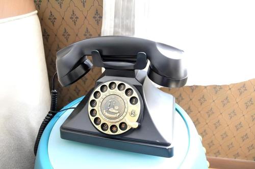 a phone sitting on top of a table at Largos Hotel in Hong Kong