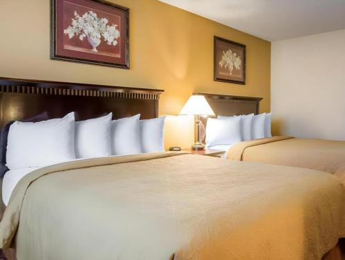 a hotel room with two beds and a lamp at Quality Inn San Bernardino - Loma Linda in San Bernardino