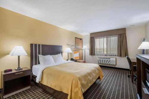 a hotel room with a large bed and a television at Quality Inn in Edgerton