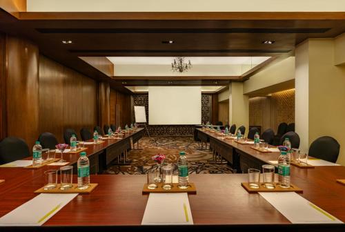 a conference room with long tables and bottles of water at The Mirador in Mumbai