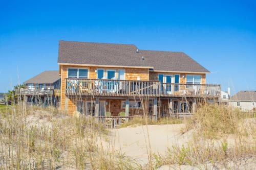a wooden house on the beach with aermott at 7041 - Toes in the Sand in Whalebone