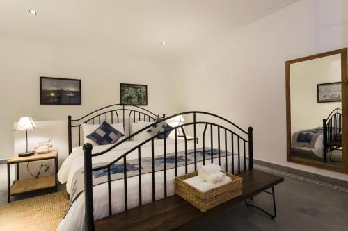 a bedroom with a bed and a mirror at Boutique Kampot Hotel in Kampot