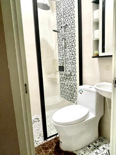 a bathroom with a toilet and a sink at Ndalem Suryo Guesthouse in Yogyakarta