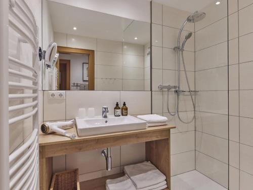 a bathroom with a sink and a shower at Holiday apartment The Neuhaus in Abtenau