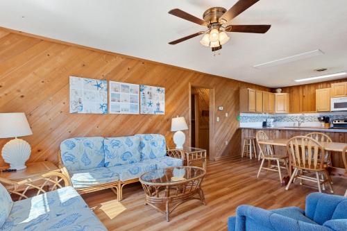 a living room with a blue couch and a table at 7141 - Geri's Place #9 in Wanchese