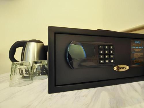 a microwave oven sitting on a table with glasses at King's Hotel in Hong Kong