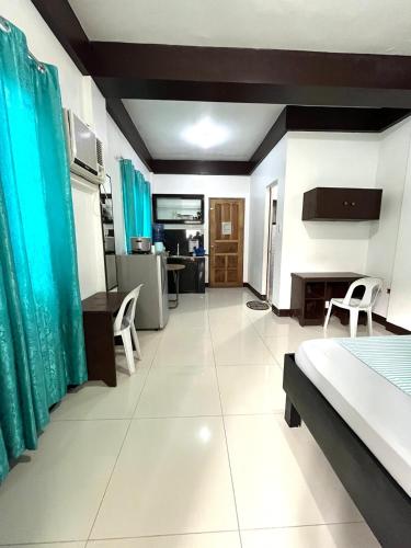 a large room with a bed and a kitchen at Longay Homestay in General Luna