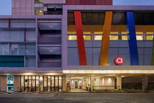a large building with a red sign on the side at Amaris Hotel Pakuan Bogor in Bogor