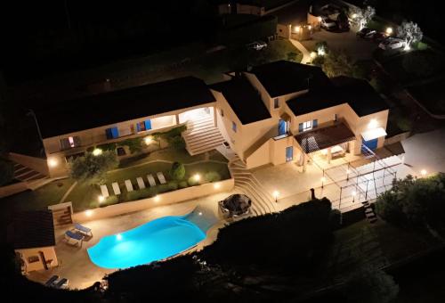 an aerial view of a house with a swimming pool at night at La Bastide Des Selves in Draguignan