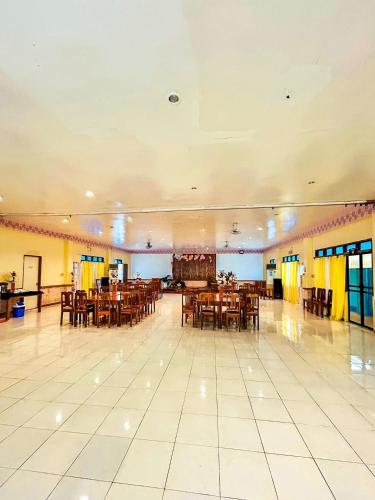 a large banquet hall with tables and chairs at Villa Paraiso Resort & Waterpark in Camiguin Island