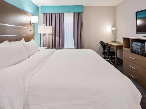 a large white bed in a hotel room at Best Western Galt Inn in Galt