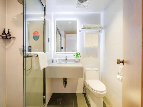 a bathroom with a sink and a toilet and a shower at GreenTree Inn Shanghai Jingan Railway Station Xinzha Road Business Hotel in Shanghai