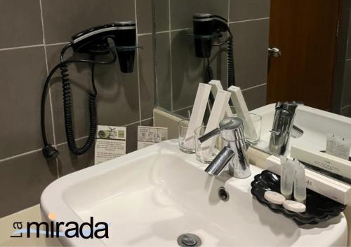 a sink in a bathroom with a shower at La Mirada Hotel in Mactan