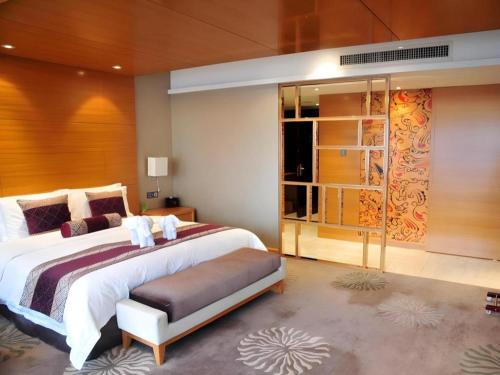 a bedroom with a large bed in a room at Changsha Huatian Hotel in Changsha