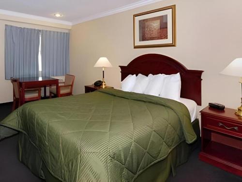 a hotel room with a large bed and a desk at Quality Inn Near City of Hope in Los Angeles