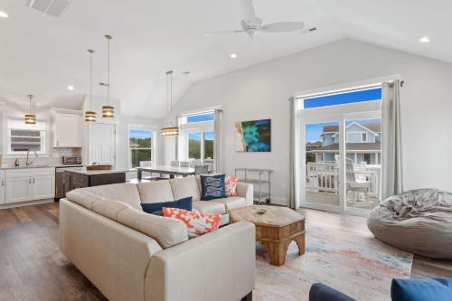 a living room with a couch and a table at 1013 - High Tides and Philly Forever in Corolla