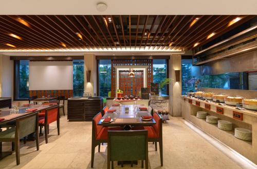 a restaurant with a dining room with tables and chairs at The Mirador in Mumbai
