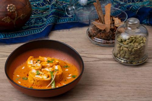a bowl of soup sitting on top of a table at The Mirador in Mumbai