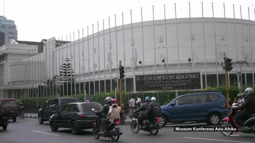 a group of people riding motorcycles in front of a building at Raffleshom Hotel in Bandung