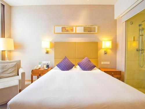 Postel nebo postele na pokoji v ubytování Inzone Garlnd Hotel Zhangqiu