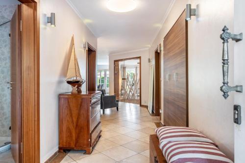 a hallway with a bed and a dresser in a room at Traumhaus Whirlpool Sauna Grill in Hamburg