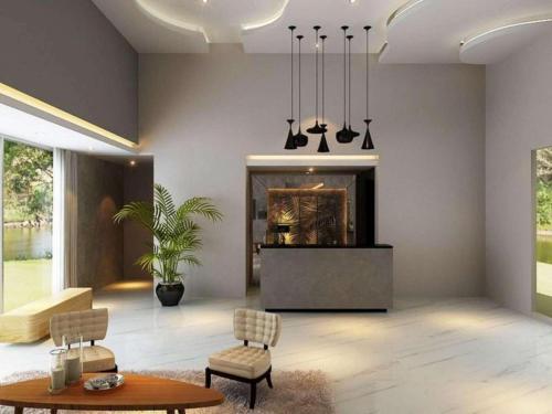 a living room with a fireplace and a table and chairs at Bogor Valley Hotel in Bogor
