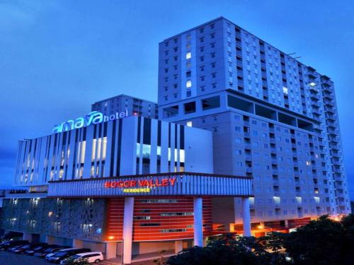 a tall building with a sign in front of it at Bogor Valley Hotel in Bogor