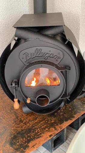 a stove with a fire inside of it at Lakeside-Hideaway in Schenkendöbern