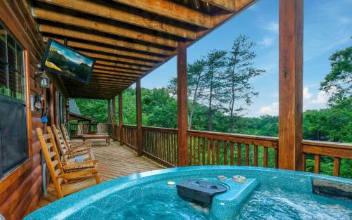 a hot tub on the deck of a cabin at Boo Boos Den in Sevierville