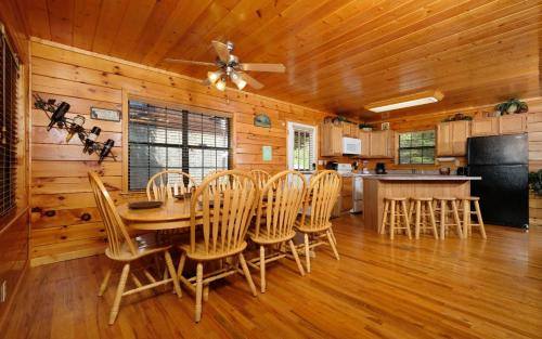 a kitchen and dining room with a table and chairs at Boo Boos Den in Sevierville