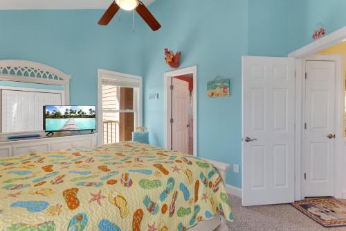 a bedroom with a bed and a ceiling fan at SCB9 - Chasin' Sunsets in Hatteras