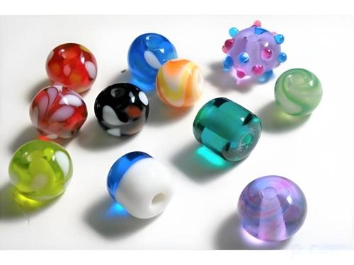 a group of different colored glass beads on a table at AKISAWA HOTEL in Shimanto