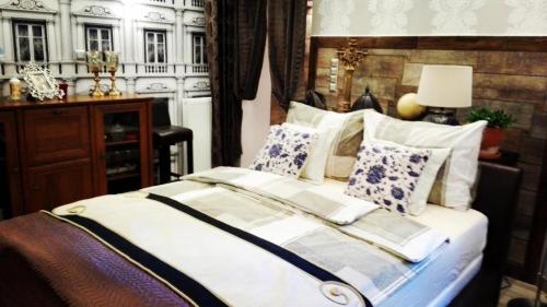 a bedroom with a large bed with pillows at Central Apartments in Poznań