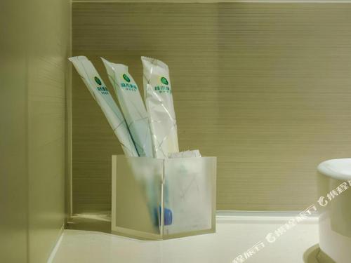 a container of toothbrushes sitting on a bathroom counter at City Comfort Inn Hotel Guiyang Normal University Yangmingci Metro Station in Guiyang
