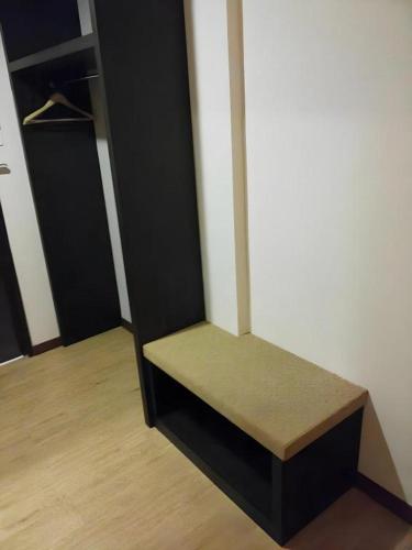 a bench sitting in the corner of a room at Eminent Hotel in Kota Kinabalu