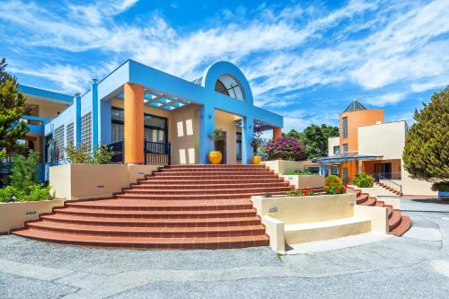 a building with stairs in front of it at Atrium Hotel in Pefkohori