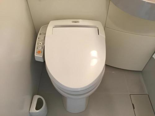 a bathroom with a white toilet in a stall at Hotel Gran View Okinawa in Naha
