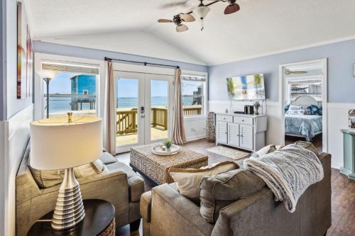 a living room with a couch and a view of the ocean at 8077 - Beachin' It in Rodanthe