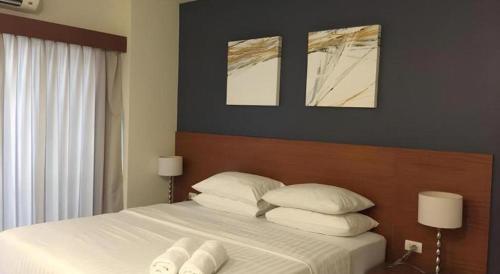 a bedroom with a bed with white towels on it at Pannapat Place in Bangkok