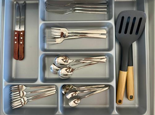 a plastic container with forks and utensils in it at Agali Studios 1 in Gialtra