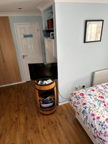 a bedroom with a bed and a desk in a room at The Buttery in Brundall