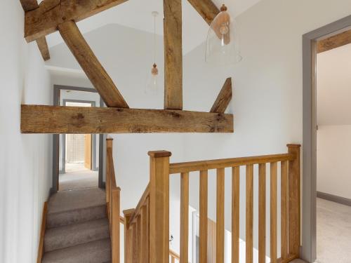 a staircase in a house with wooden beams at The Foundary - Uk36319 in Whitchurch