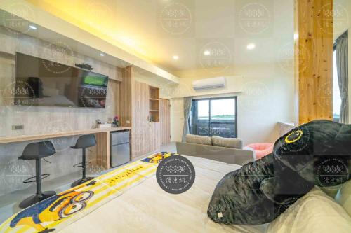 a room with a large bed with a surfboard on it at Lanyang Beach Villa in Wujie
