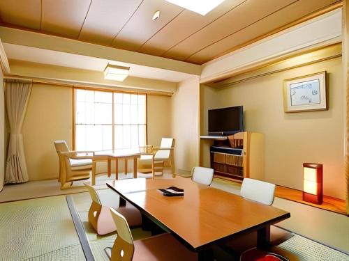 a living room with a table and a dining room at Yuzawa New Otani in Yuzawa