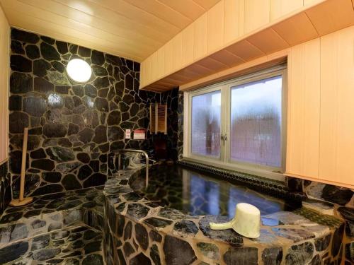 a room with a swimming pool with a cowboy hat in it at Yuzawa New Otani in Yuzawa