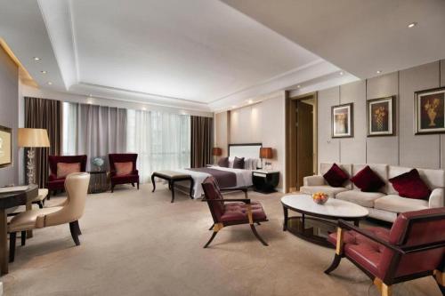 sala de estar amplia con sofá y cama en YM Gold Olives Harmony International Hotel, en Shenzhen